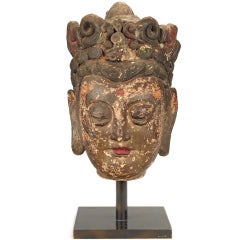 An extremely rare polychrome stucco head of Guanyin