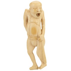 A Humorous Ivory Netsuke Of A Man Tying His Loin Cloth