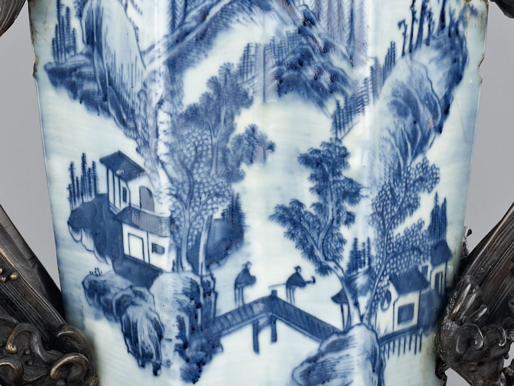 An extraordinary and unique works of art, comprised of the marriage of a late 18th century Chinese blue-and-white vase decorated with a literati landscape of Taoist Paradise. This unusual porcelain inspired a skilled Japanese bronze artist to create