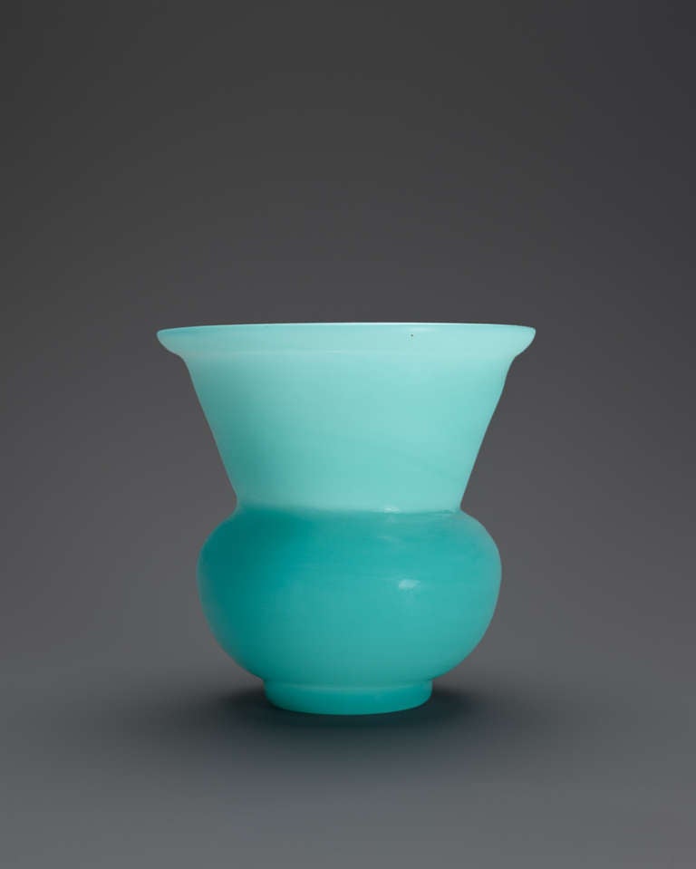 A translucent “sky blue” spittoon, zhadou, with a small globular body opening to a large flaring mouth, resting on a short recessed foot incised with a Qianlong nian zhi (made during the Qianlong period) four-character mark within a