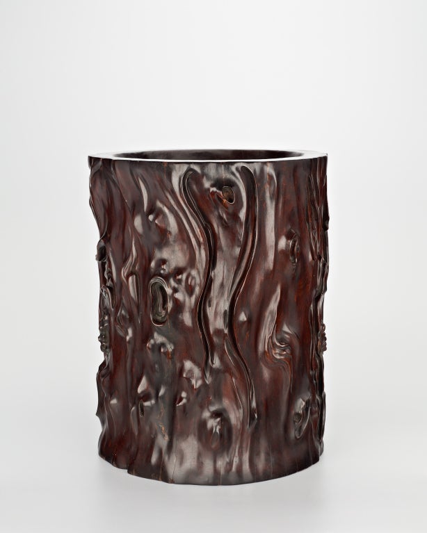 A very large and heavy cylindrical pot made to hold scrolls, the outside walls carved to form the natural skin of a tree trunk.