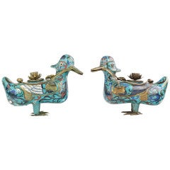 A pair of cloisonné mandarin ducks on a large wood stand