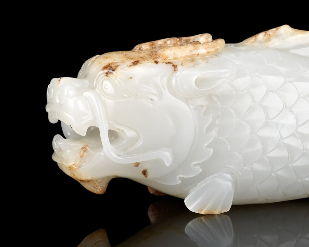 A white jade carving of a “fish-dragon”