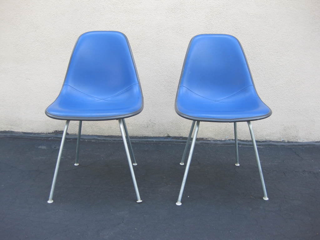 Royal blue vinyl with black trim and white fiberglass back. Steel legs. Price is for pair.