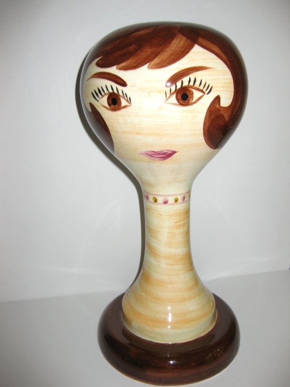Stangl made these in the 1960s to be used  for store displays in order to display wigs or hats. They were made in brunette, blonde and red. Glazed ceramic with painted face and hair. A great and fun addition to any dressing room!