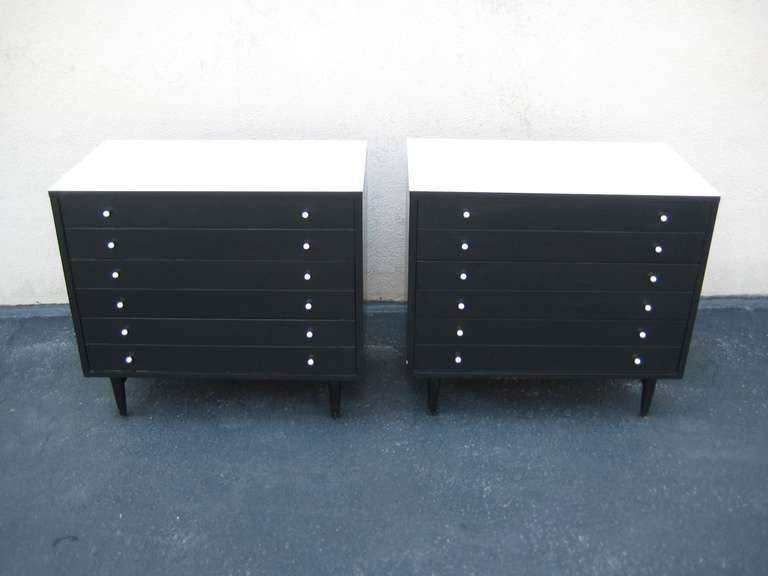Black with white top. 12 knobs on each dresser.  Each have 3 drawers and each drawer is 7
