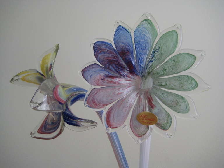 Unused Condition. Still retains original marking sticker. Blown Glass Murano flowers perfect for a vase. Vase in photo not included. We only used the clear vase for photo purposes so entire stem can be viewed. Mutli-colored blue, yellow, green,
