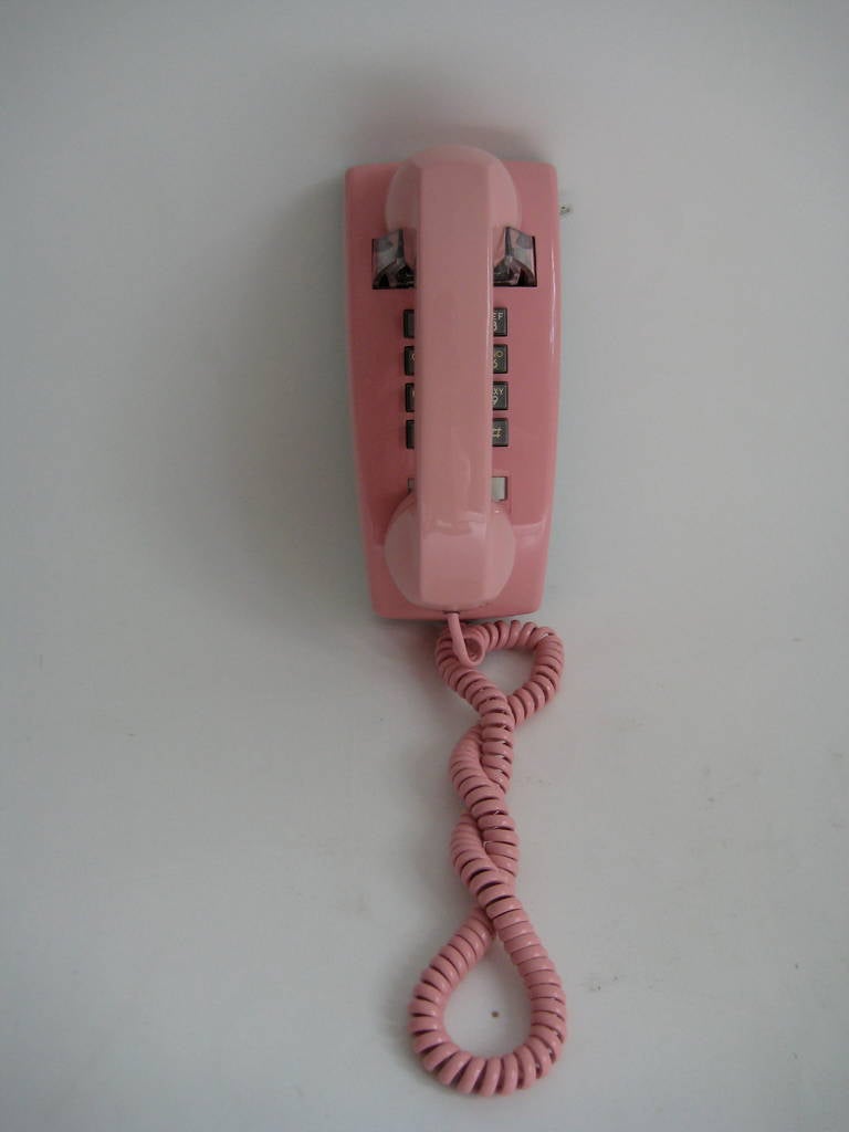 Late 1970s - early 1980s wall mount telephone in  Pepto Bismol Pink.
Vey New Wave and Pretty in Pink! Excellent Condition.