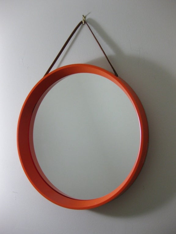 Orange  framed mirror with brown leather strap for hanging. Metal hardware. Marked made in Denmark TH. POSS' EFTF., COPENHAGEN