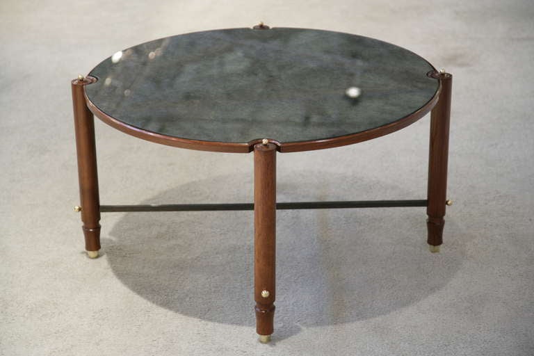 A beechwood and polished steel, round, Gueridon/cocktail table with gilt/bronze highlights and original leaf-motif, 