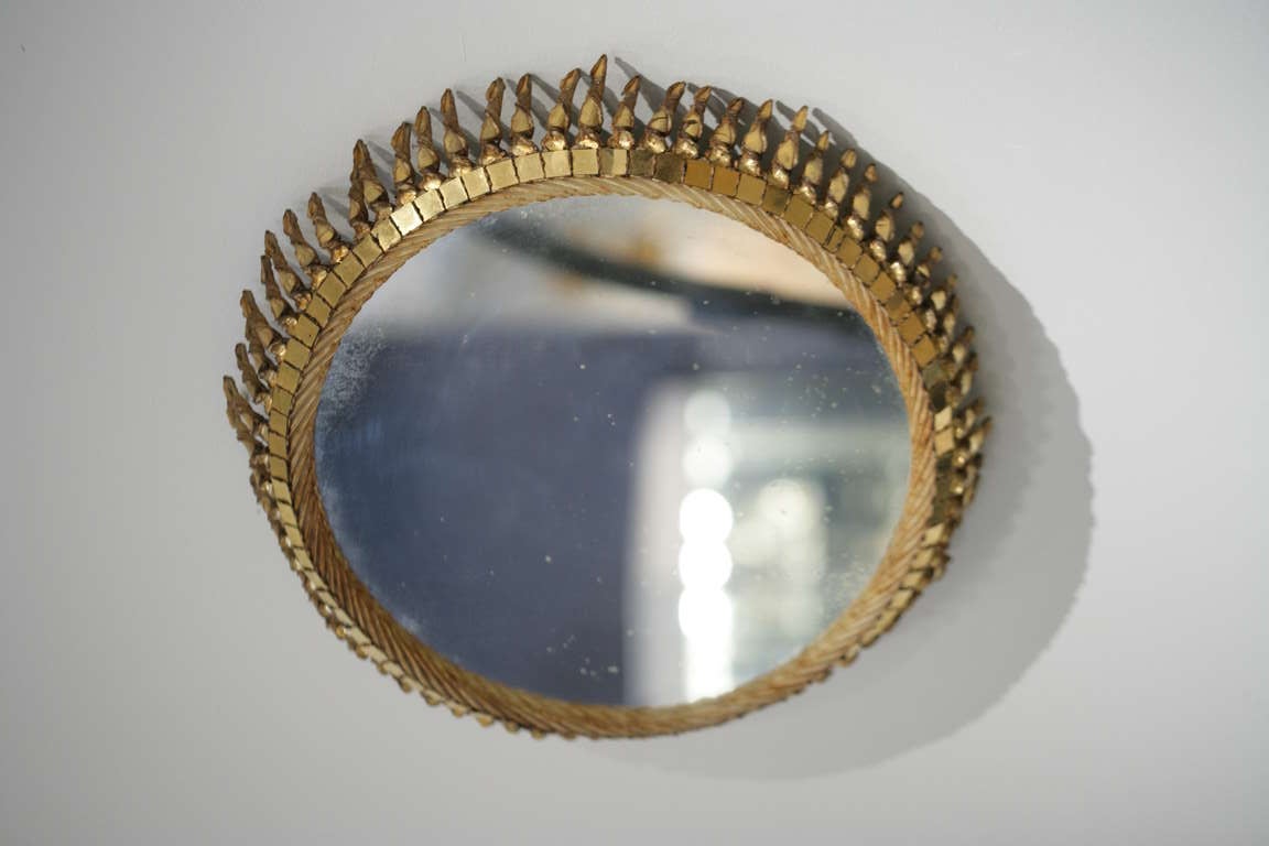 "Grand Soleil Torsade", an exceptional, Champagne Talosel-resin and gilt glass mirror by Line VAUTRIN (1913-1997), 
Reverse incised signature "Line Vautrin" 
France - circa 1958.