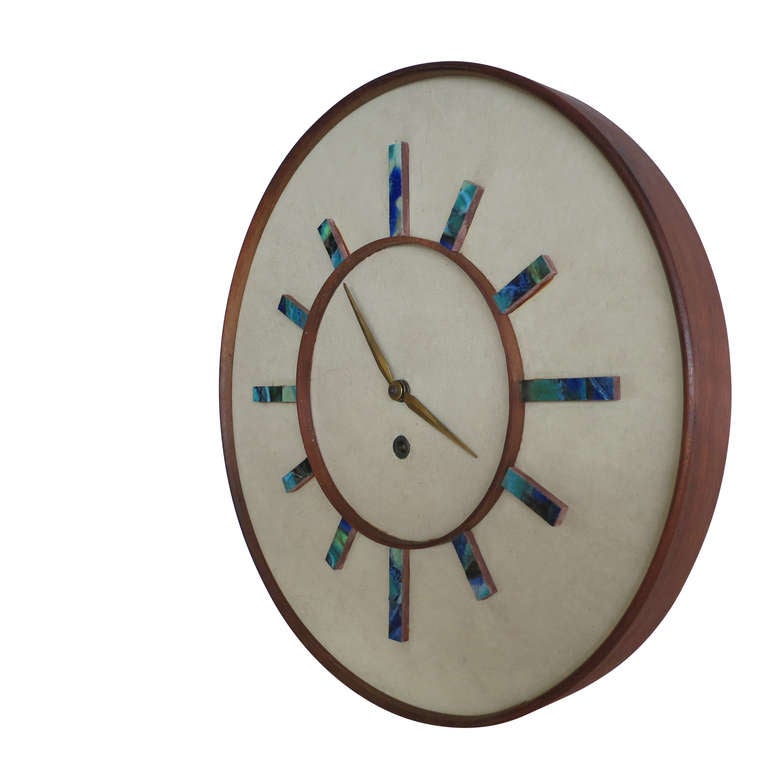 This is a seldom seen Harris Strong wall mounted clock. The German made eight day mechanical movement keeps perfect time, and the clock retains its original key for winding. Numbers on the clock face are described with Harris Strong's ceramic tile.