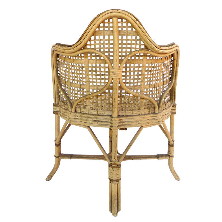 A French child's chair of woven rattan with caned back.  When the child sits, the music begins. The wind-up music box features two songs: The Parade of the Wooden Soldiers and an unidentified minuet.