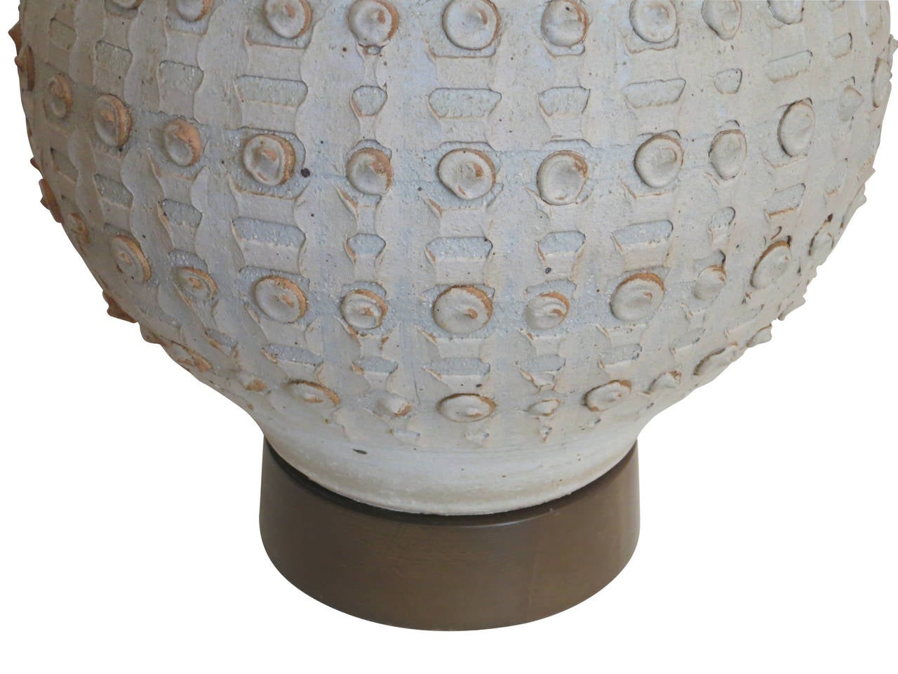 An exceptional example of Bob Kinzie's studio pottery. This large piece sits atop a wood base. The raised pattern repeats around the vessel.The height is measured to the top of the socket.