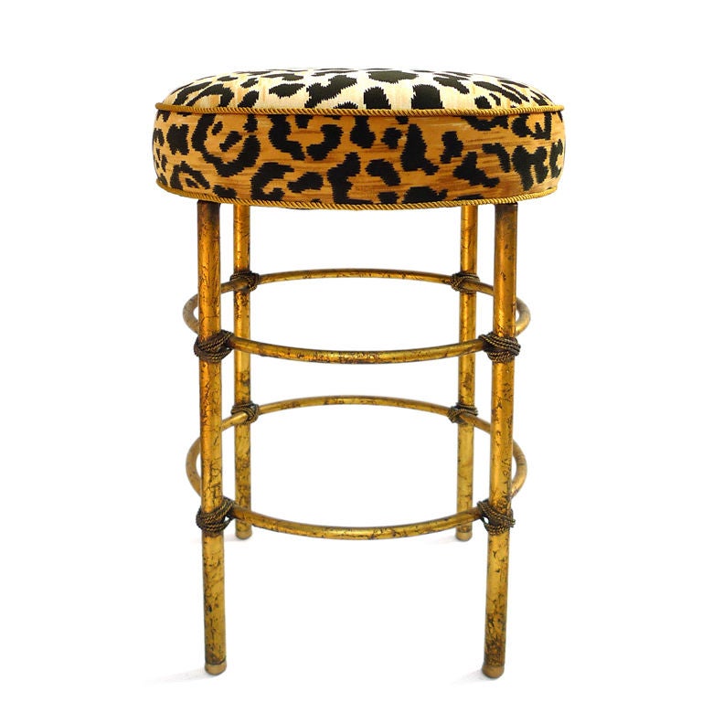 Italian gilt metal stool with faux leopard cushion.  Legs are accented with metal cord wraps