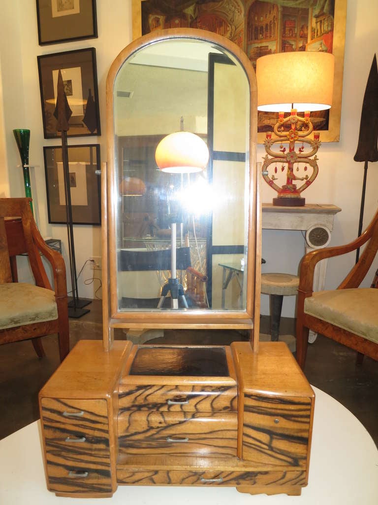 Elegant tabletop vanity from the Japanese Taisho period. The cabinet has macassar wood drawer fronts and a black lacquer inset top. The mirror is edged with a slim bevel.