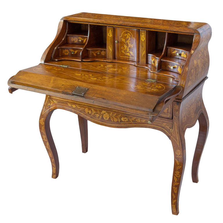 A beautifully detailed desk with one drawer. The drop front opens to reveal a fitted interior to include two secret compartments. The overall floral marquetry design is in excellent condition with good color. A 1938 bill of sale from a Parisian