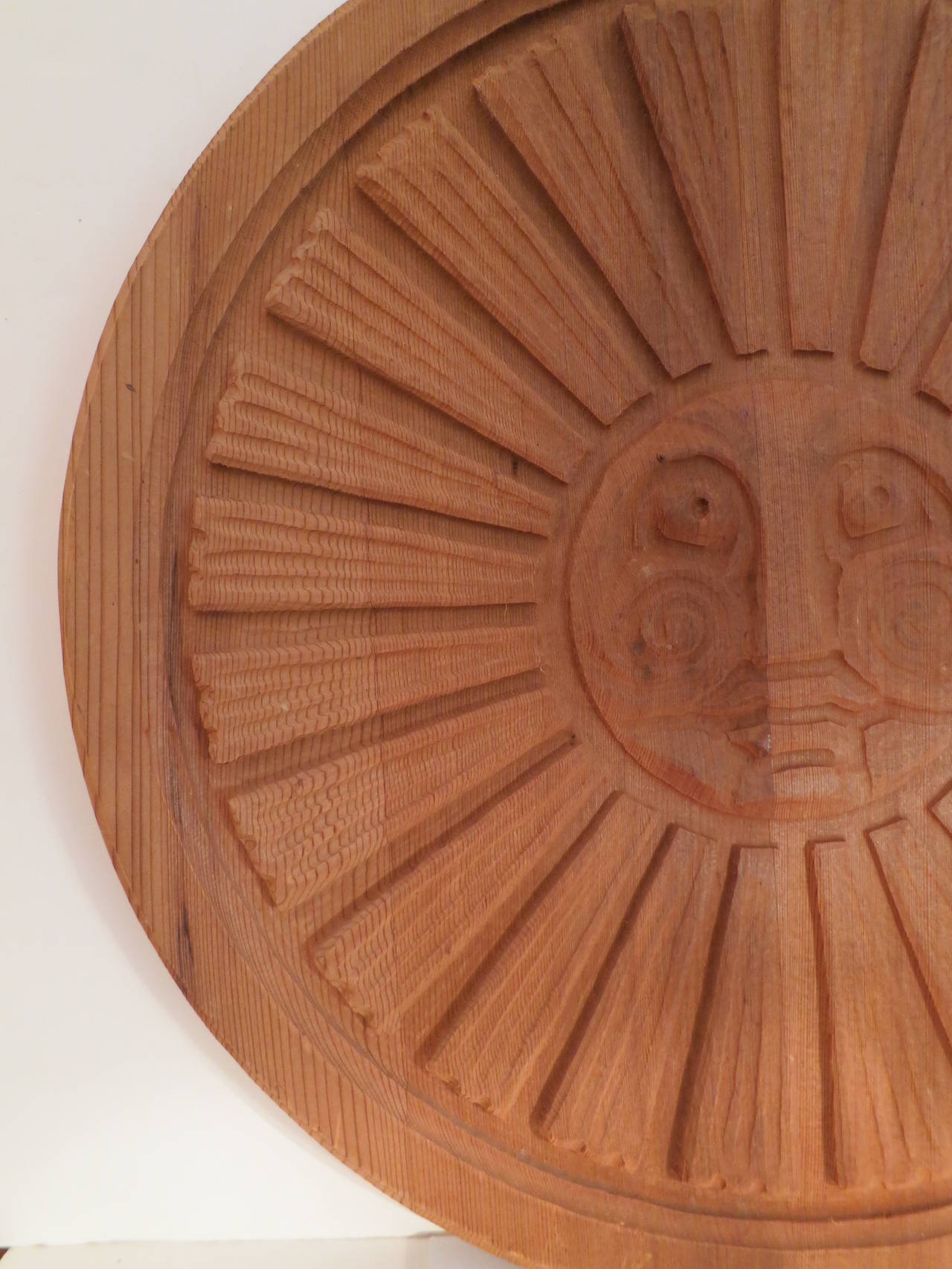 Early piece by Sherrill Broudy of Forms and Surfaces of carved, redwood sun.