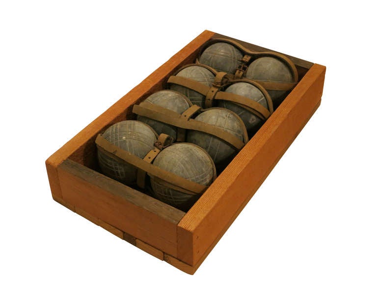 Complete set of eight bocce balls with original leather straps. Each ball measures 3