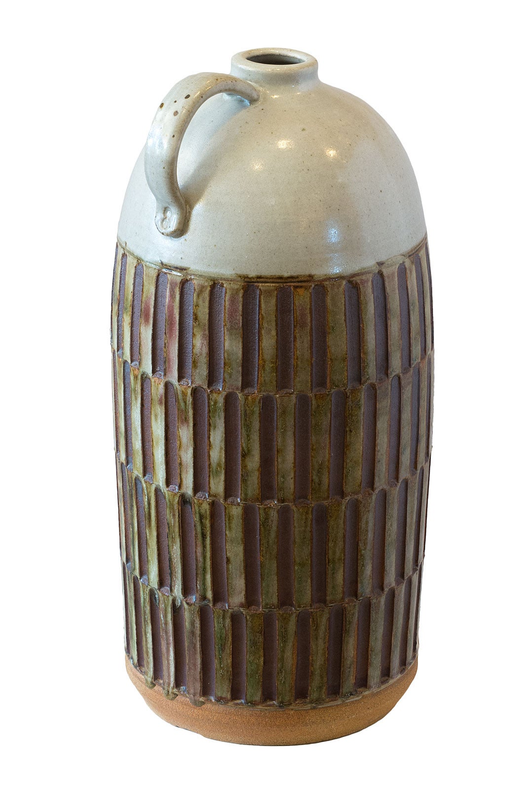This over=sized glazed earthenware vessel is in the style of Brent Bennett. The roughened arch formations at the base nicely contrast with the smooth, cool glaze of the top and with the handle of the cylinder.