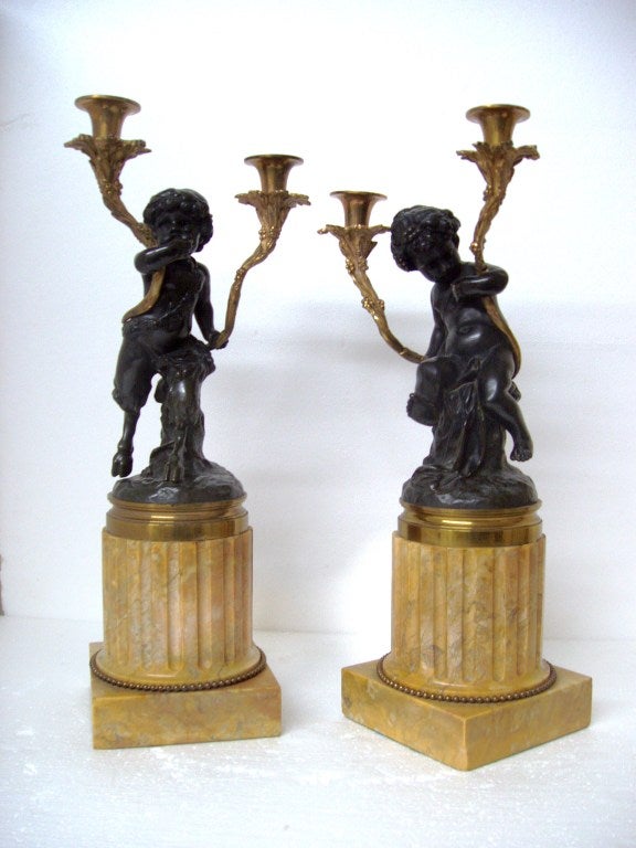 Pair of bronze cherubs on fluted marble columns