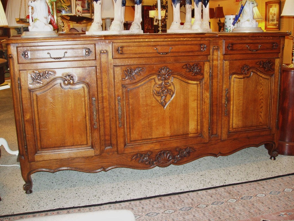 C. 1900 French, carved oak console. Three drawers and cupboard storage below.