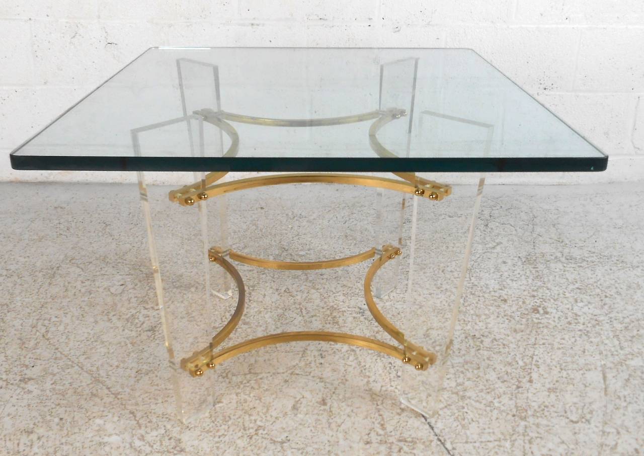 Lucite base with glass top and brass band accents. Make a great sofa end table or small coffee table, letting you expose the hardwood floors or decorative rugs.

(Please confirm item location - NY or NJ - with dealer).