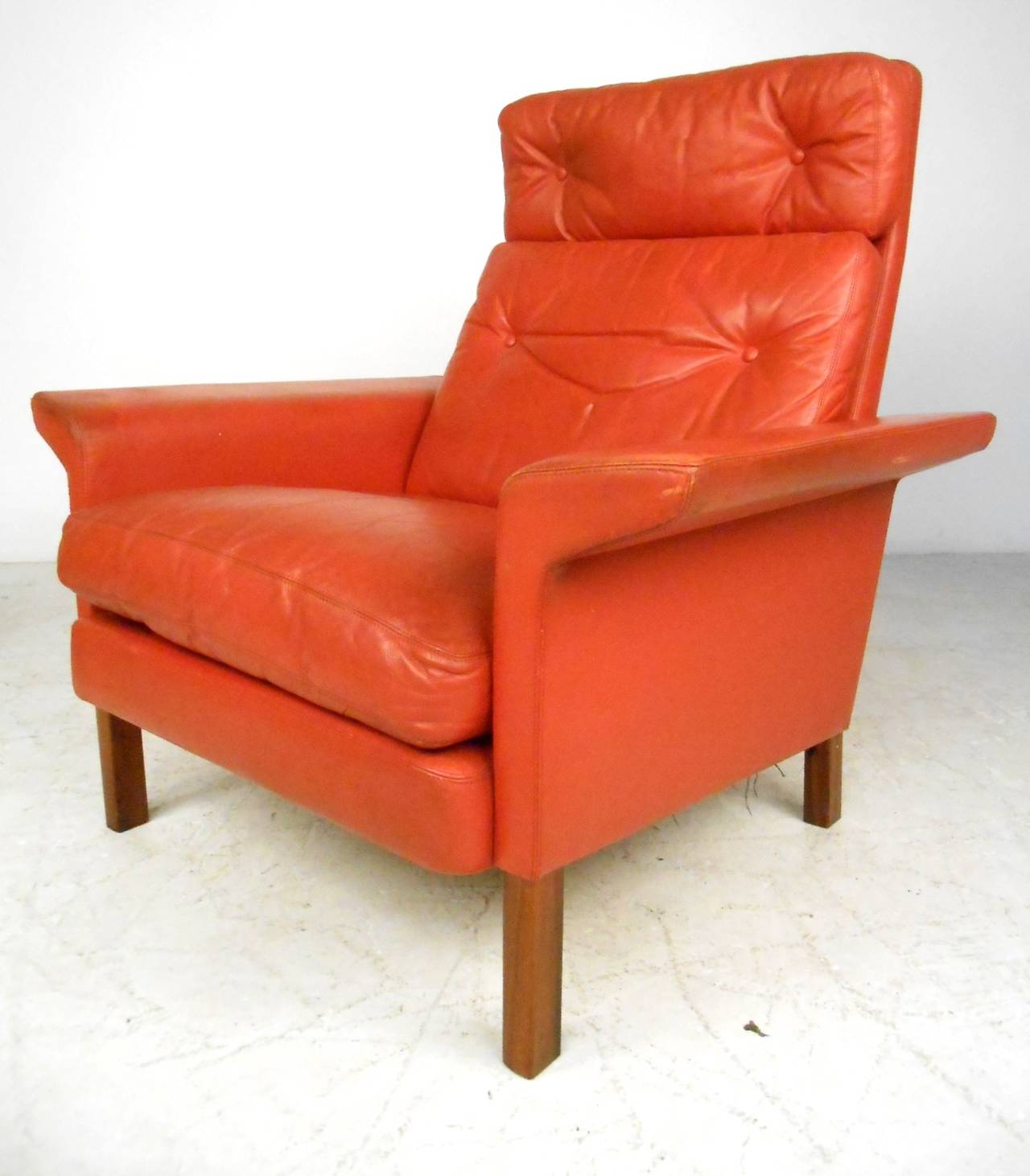 This beautiful vintage leather lounge chair comes with matching ottoman, and feature the unique wide sculpted armrests made famous by Danish designer Hans Olsen. Quality Mid-Century construction makes this a unique addition to any interior. Please