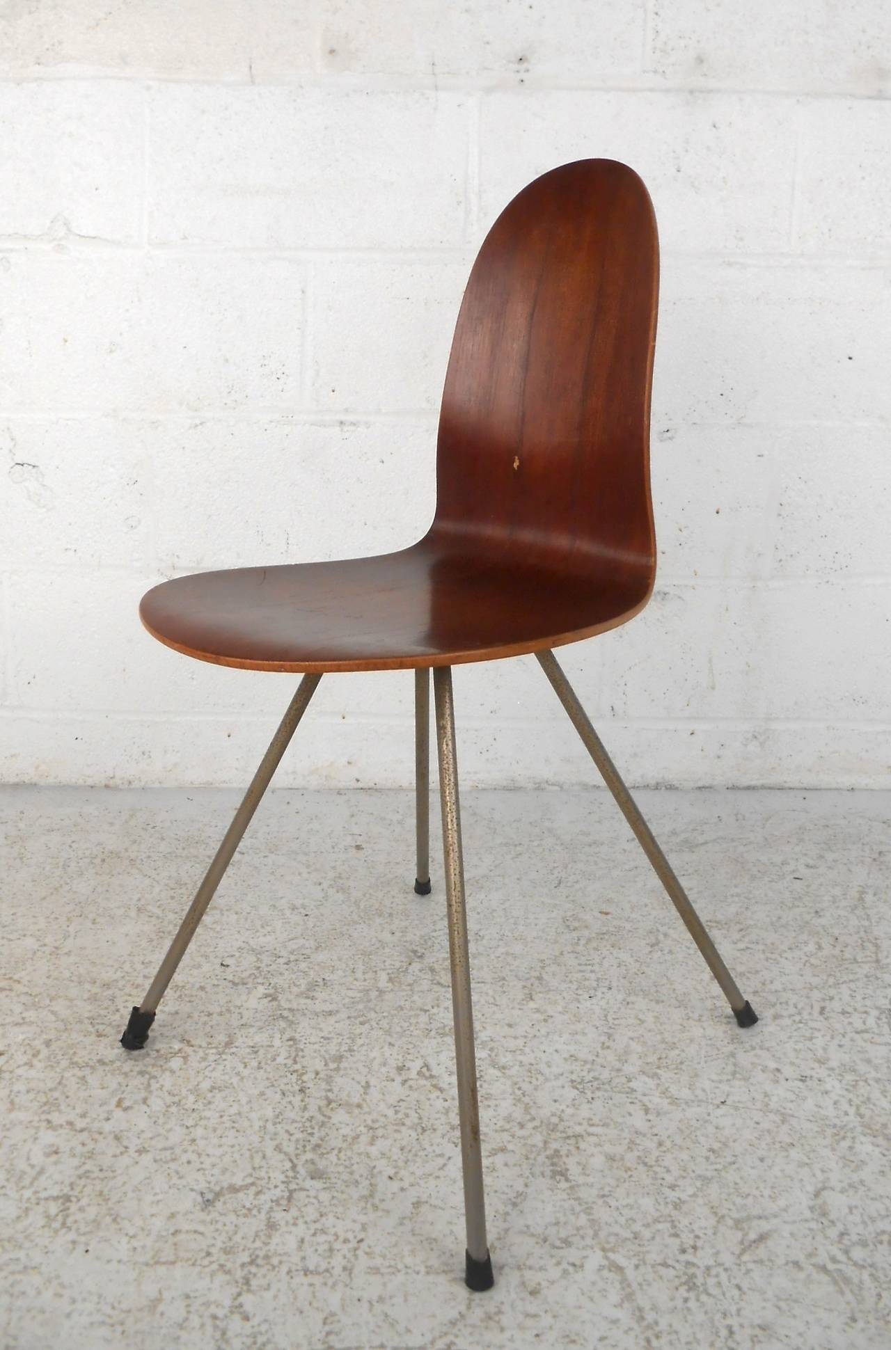 Mid-Century Modern Danish chair from Illums Bolighus, featuring strong steam formed one-piece seat and back set on sturdy metal legs. Well-made Danish design with a modern flair.

(Please confirm item location - NY or NJ - with dealer).