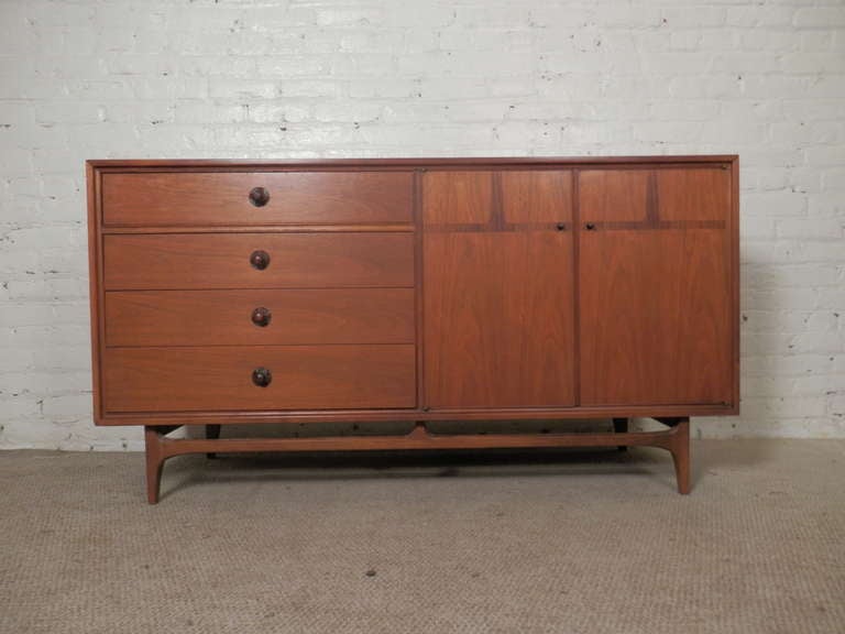 Very attractive sideboard with inlaid rosewood and sculpted rosewood pulls. Sleek modern lines and elegant legs.

(Please confirm item location - NY or NJ - with dealer)