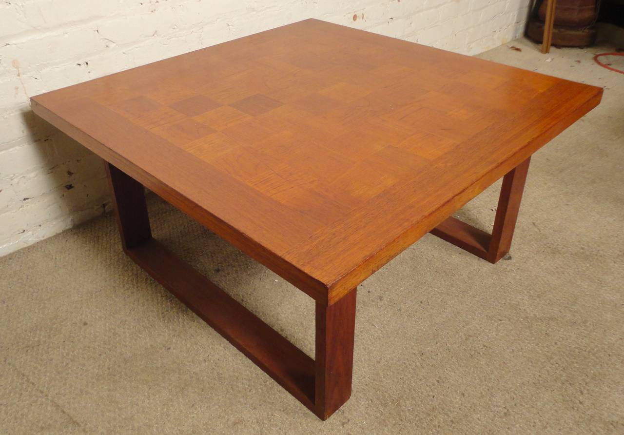 Square coffee table with patchwork top designed by Arne Vodder. Set on sled legs with square dovetail joints. Solid design and construction.

(Please confirm item location - NY or NJ - with dealer)