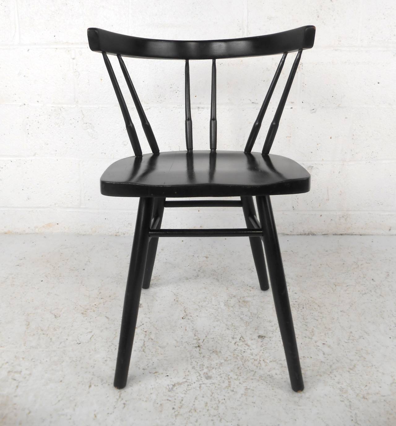 Made by Spainhour Furniture Co., in the style of Paul McCobb Planner Group.  This solid maple chair features a black lacquer finish, solid wood construction and tapered legs which offers a unique modern design to any home or office space.

Please