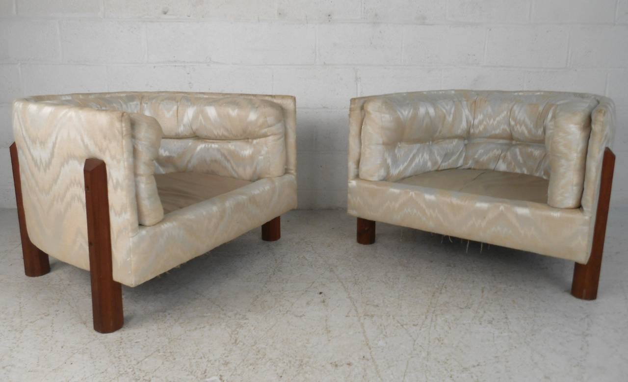 This pair of vintage chair feature unique woodnen frames, tufted backs and a comfortable barrel back design. Ready for reupholstery, this pair will make a beautiful addition to any modern interior. Please confirm item location (NY or NJ).