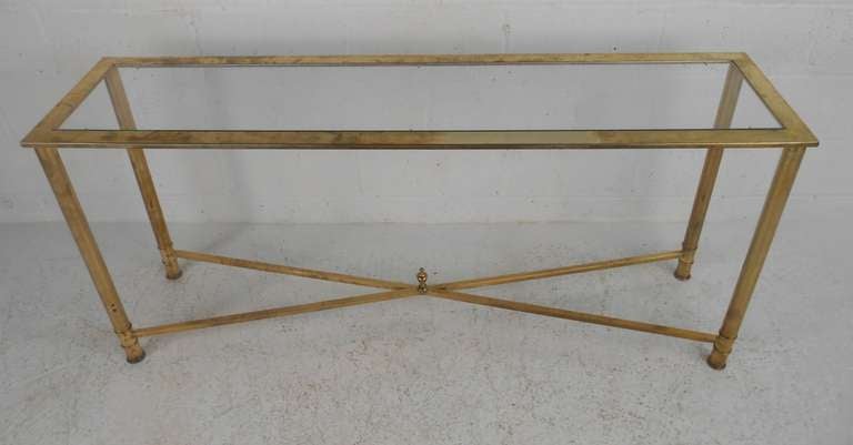 Elegant brass & glass console table. Please confirm item location (NY or NJ) with dealer.