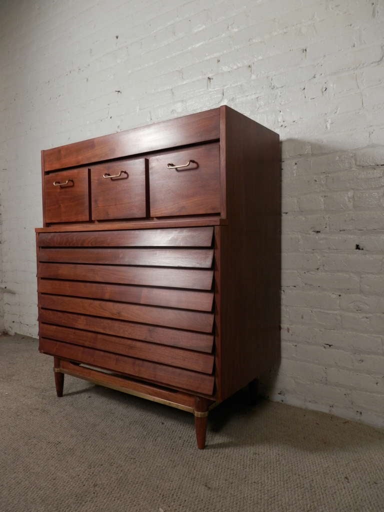 Mid-century modern design with flair! 
Total of seven drawers for plenty of bedroom storage. Slatted front gives fashion and function, doubling as the drawers pulls. Nicely accented with brass hardware.

(Please confirm item location - NY or NJ -