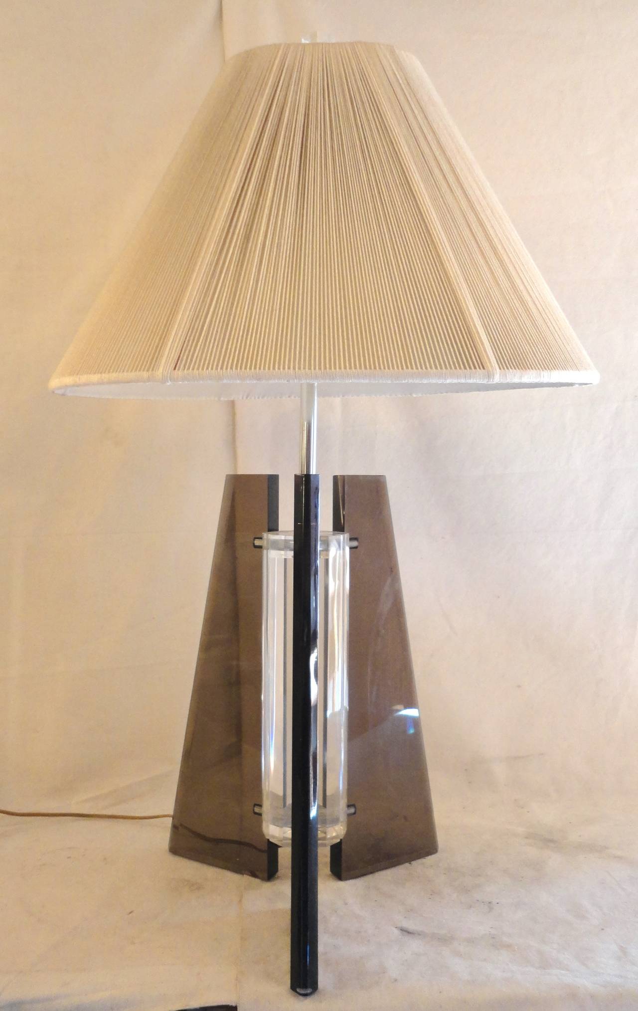 Vintage modern table lamp with tri-pod base. Attractive smoked glass base around a clear lucite center. Rope shade in good shape, adds a textural element.
36"high to the top of the finial.

(Please confirm item location - NY or NJ - with