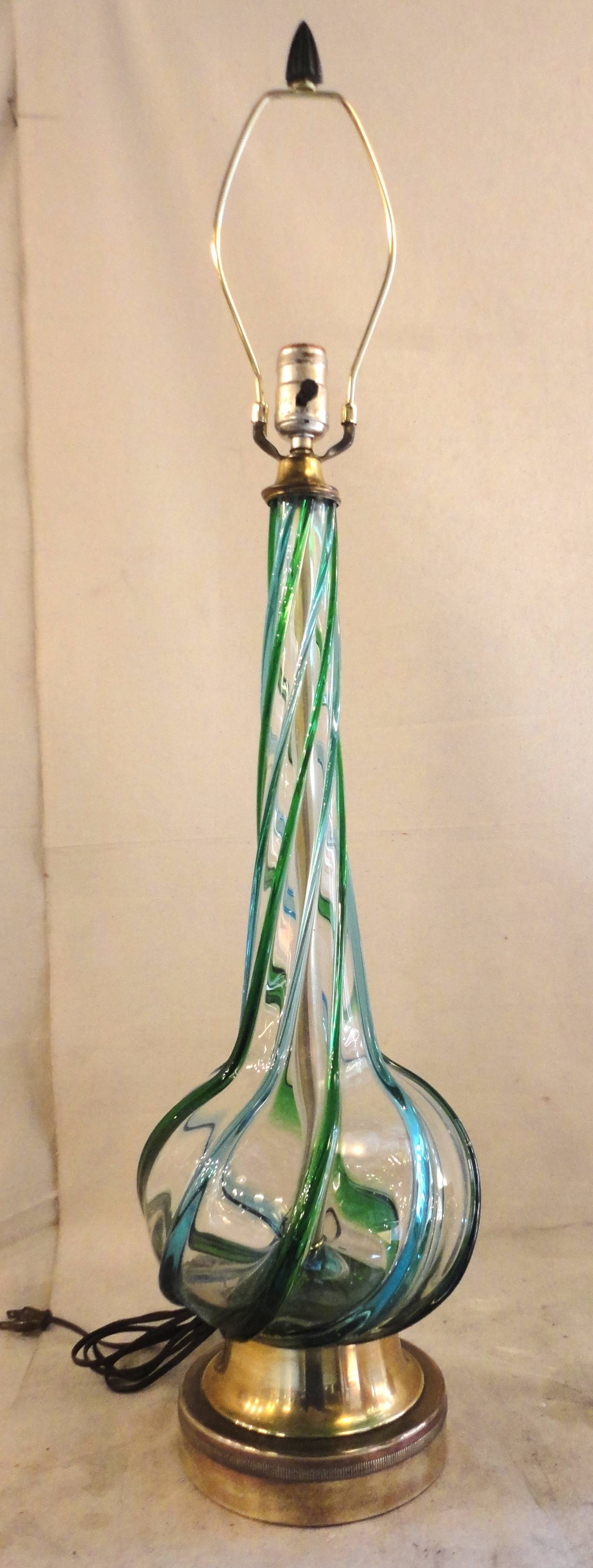 Beautiful Murano table lamp with hand blown twist style. Polished brass base with spiral blue and green coloring.
35