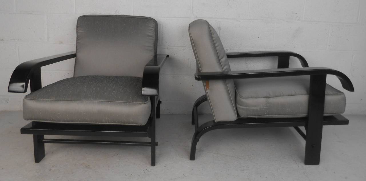 Stylish mid century Russel Wright lounge chairs produced by Conant Ball. The impressive sculpted frames feature bentwood arms and legs, black lacquer finish, and mid century styling. Please confirm item location (NY or NJ) with dealer.