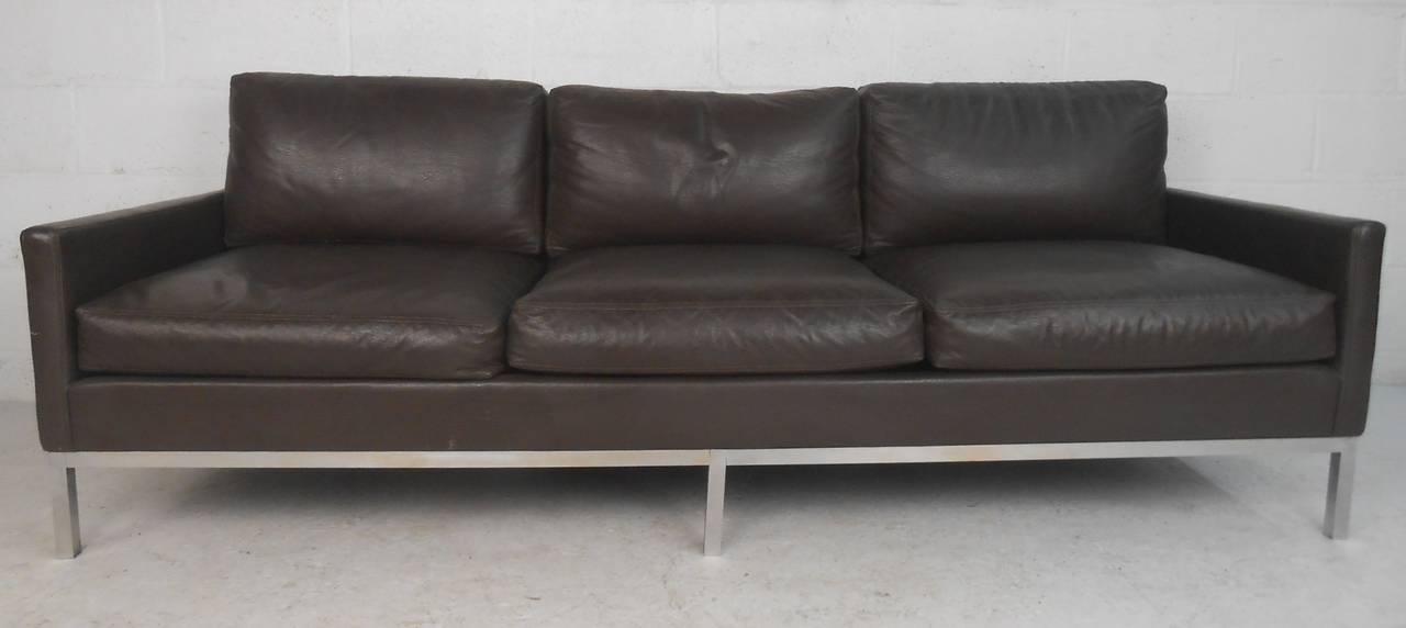 Three seat deep brown leather sofa on chrome-plated base in the style of Florence Knoll. Please confirm item location (NY or NJ) with dealer.