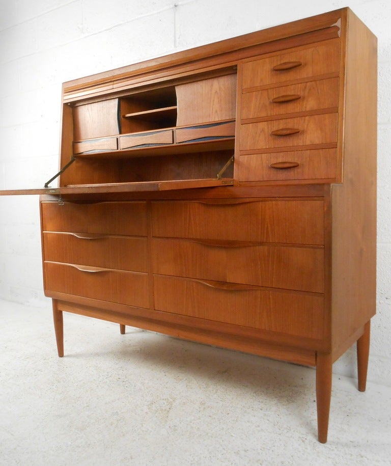 Beautiful teak secretary designed by Ib Kofod Larsen in the mid sixties. Multiple drawers both obvious and hidden, sliding doors, storage compartments and a writing space create a compact & effective work station. Please confirm item location (NY or