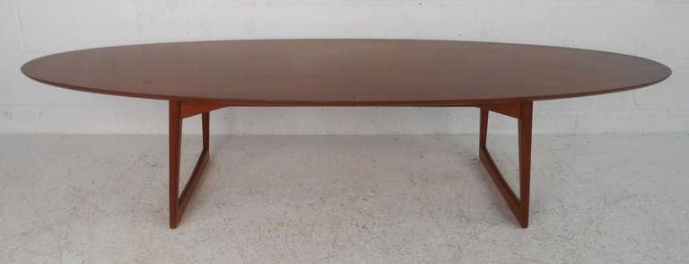 Nicely designed elliptical shaped teak table with sled leg base. Danish control mark and branded 