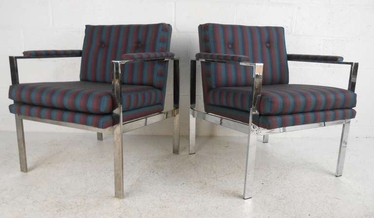 Stylish pair of upholstered armchairs with chrome-plated flat-stock frames in the style of Milo Baughman. Comfortable  seating with tufted vintage fabric, cubist modern design, and padded armrests add to the vintage charm of the Mid-Century chairs.