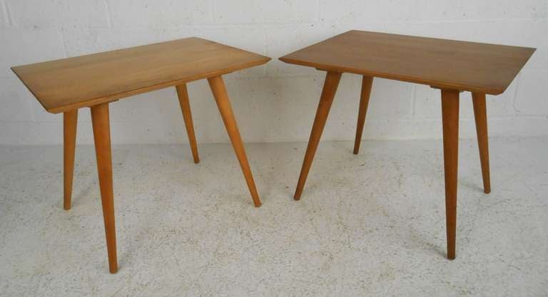 Pair of solid maple, smaller scale end tables by Paul McCobb for Planner Froup. Stylish tapered legs and simple yet elegant mid-century design add to the mid-century modern appeal of the pair. Quality craftsmanship with beveled edges, splayed legs,