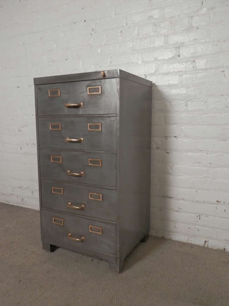 Five drawer industrial metal file cabinet in bare metal finish with accenting brass hardware. Comes with key.

(Please confirm item location - NY or NJ - with dealer)