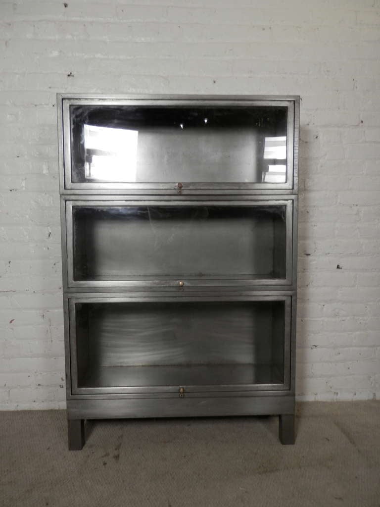 Vintage metal barrister bookcase with sliding glass doors. Refinished in a bare metal style for a handsome industrial look.

(Please confirm item location - NY or NJ - with dealer)