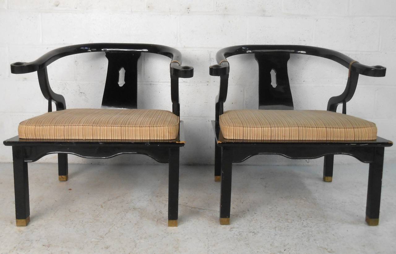 This pair of unique vintage James Mont style armchairs feature stylish sculpted backs, brass feet, comfortable seats, and make a great addition to any interior space. Please confirm item location (NY or NJ).