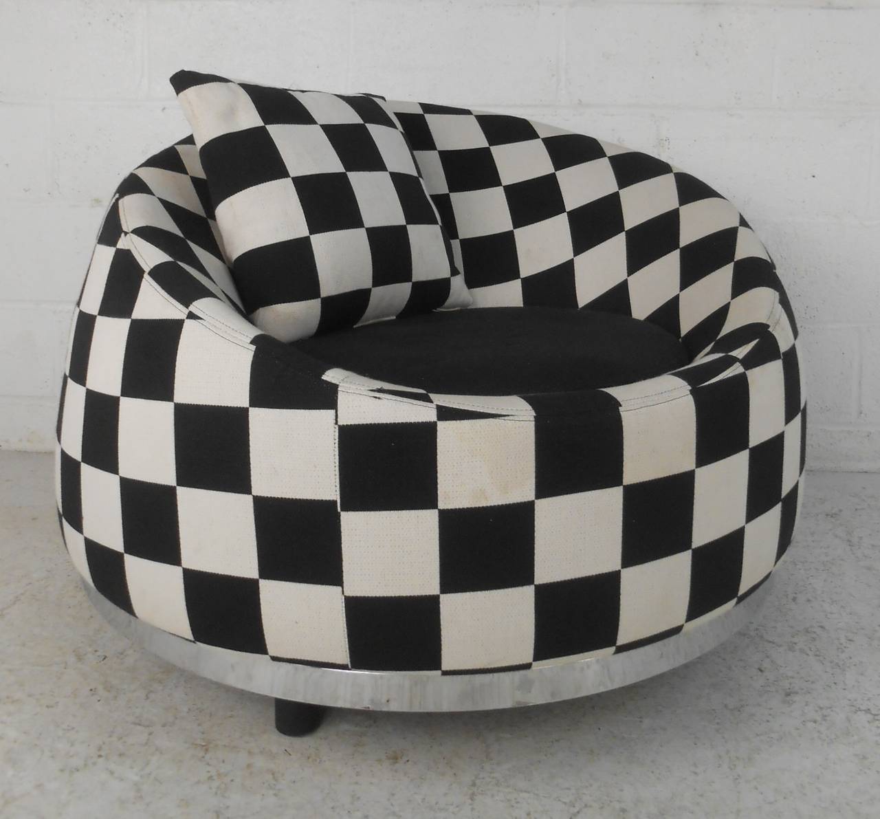This stylish contemporary modern club chair features chrome trim, black and white checkered upholstery, and uniquely shaped seat back. Very comfortable, Italian made tub chair with vibrant geometric pattern upholstery. Please confirm item location