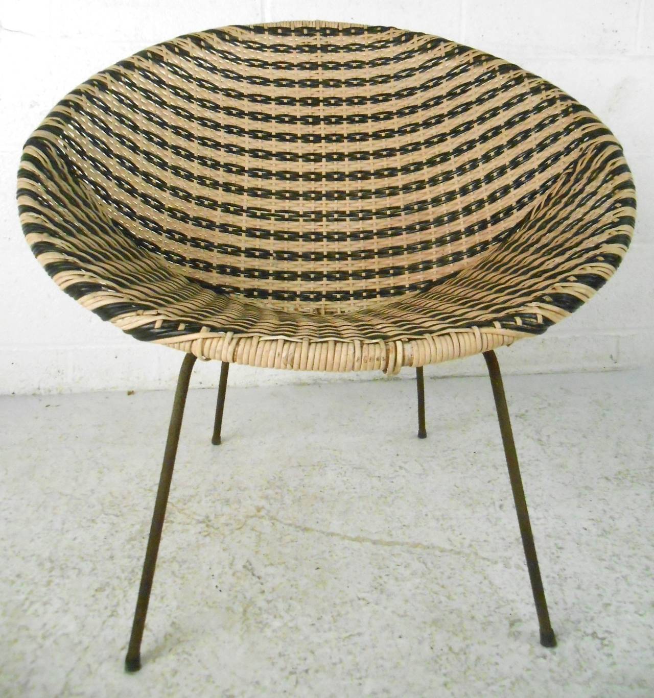 This unique vintage design combines simplicity and style, and is well suited to either interior or porch use. Woven vinyl & wicker combine in comfortable womb like design, framed on cast iron legs. Please confirm item location (NY or NJ).