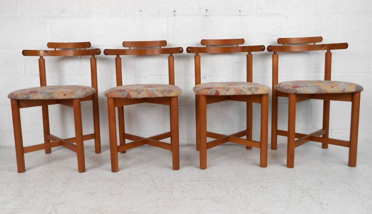 Set of four uniquely shaped dining chairs, quality teak construction by Gangso Mobler A/S of Denmark. Perfect set for kitchen or dining room, comfortable rounded back combined with cross frame stretchers make these a perfect addition to any
