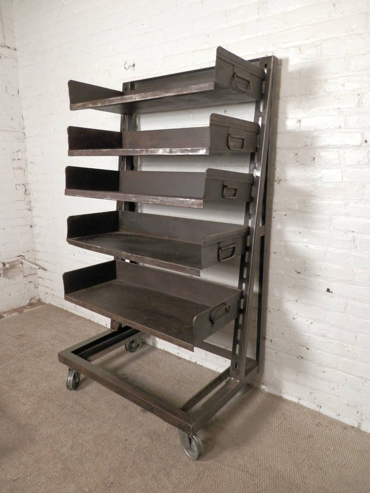 Unique factory shelving unit on metal casters. Heavy duty adjustable shelves with handles. Makes for a great bookshelf or kitchen pantry.

(Please confirm item location - NY or NJ - with dealer)
